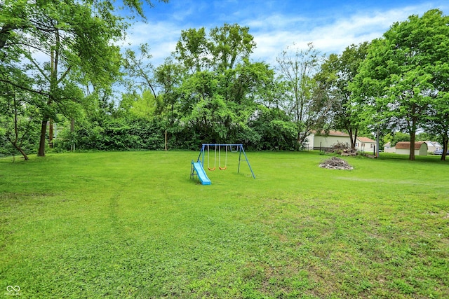 2747 E Midland Rd, Indianapolis, IN 46227 - view of grassy yard with a playground and an outdoor fire pit
