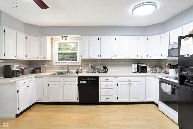 2747 E Midland Rd, Indianapolis, IN 46227 - kitchen featuring black appliances, a sink, decorative backsplash, and light wood-style floors