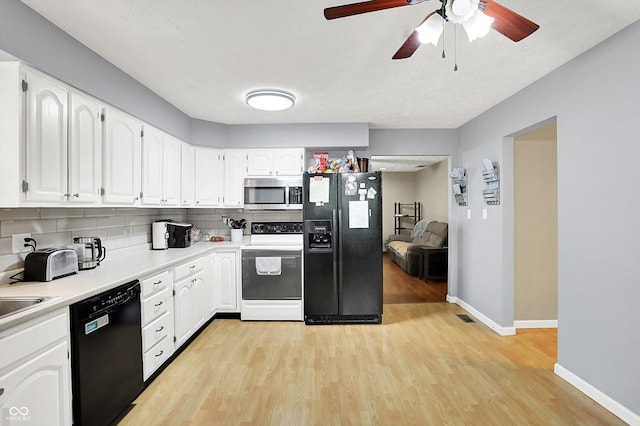 2747 E Midland Rd, Indianapolis, IN 46227 - kitchen with black appliances, backsplash, light wood-type flooring, ceiling fan, and white cabinetry