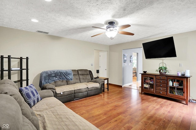 2747 E Midland Rd, Indianapolis, IN 46227 - living room featuring a ceiling fan, light wood-style flooring, baseboards, a textured ceiling, and recessed lighting