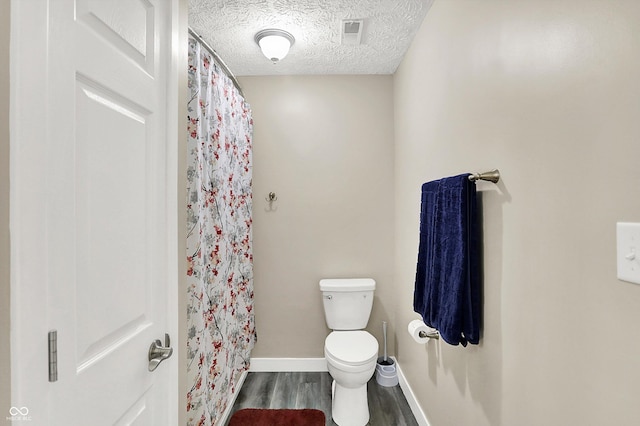 2747 E Midland Rd, Indianapolis, IN 46227 - full bathroom with toilet, wood finished floors, a textured ceiling, baseboards, and a shower with shower curtain