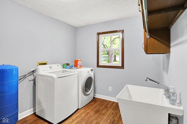 2747 E Midland Rd, Indianapolis, IN 46227 - washroom with wood finished floors, washing machine and clothes dryer, baseboards, and a textured ceiling