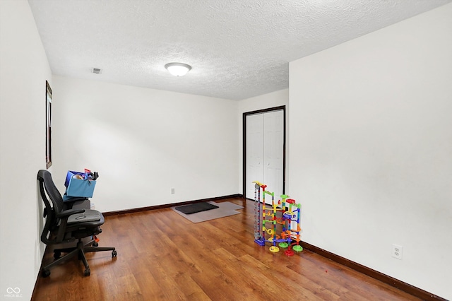 2747 E Midland Rd, Indianapolis, IN 46227 - playroom featuring wood finished floors, baseboards, and a textured ceiling