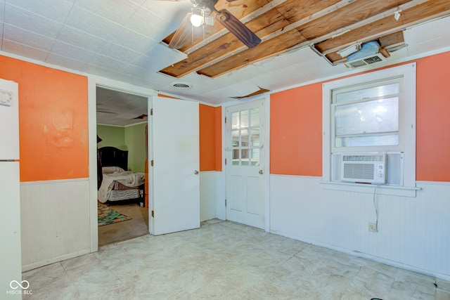 unfurnished room with cooling unit and ceiling fan