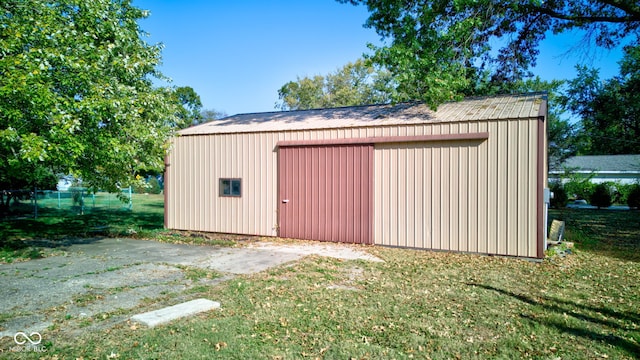 view of outdoor structure featuring a lawn