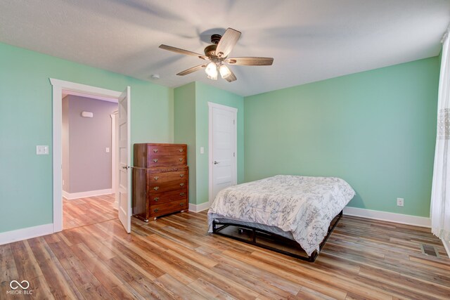 bedroom featuring light wood-type flooring and ceiling fan