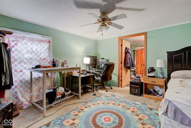 bedroom with crown molding, ceiling fan, and carpet