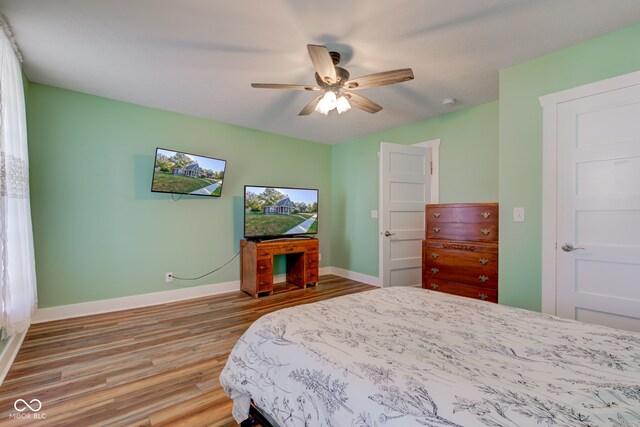 bedroom with wood-type flooring and ceiling fan