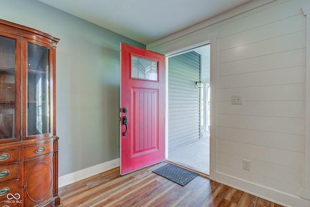 foyer with light wood-style floors and baseboards