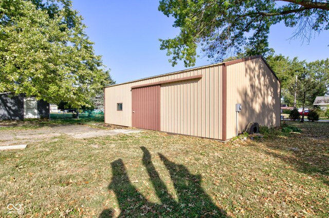 view of outbuilding with a garage and a yard