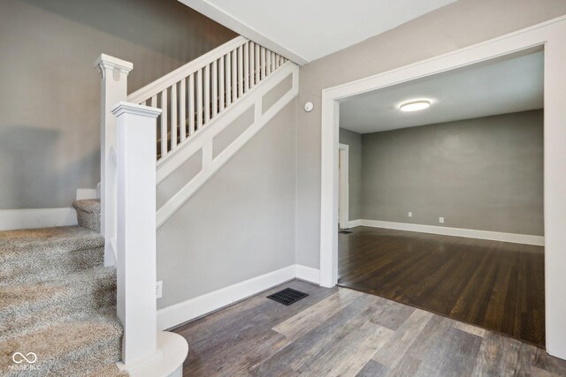 stairway with hardwood / wood-style flooring