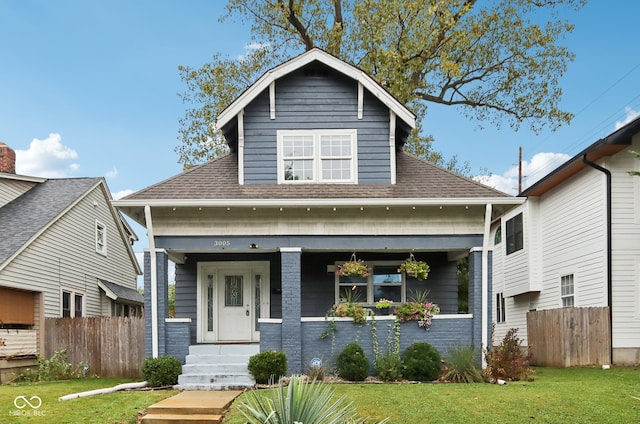 bungalow featuring a front yard and a porch