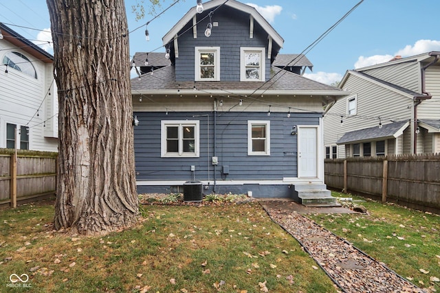 3005 Broadway St, Indianapolis, IN 46205 - rear view of property with a fenced backyard, a lawn, a shingled roof, and entry steps