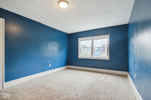 carpeted spare room with a textured ceiling