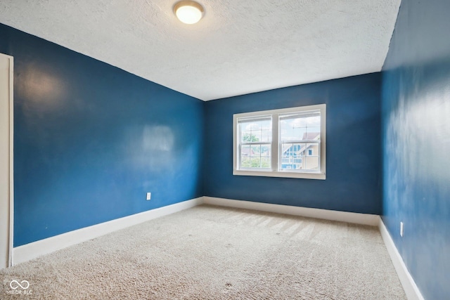 3005 Broadway St, Indianapolis, IN 46205 - carpeted empty room featuring baseboards and a textured ceiling