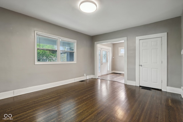 spare room with dark wood-type flooring