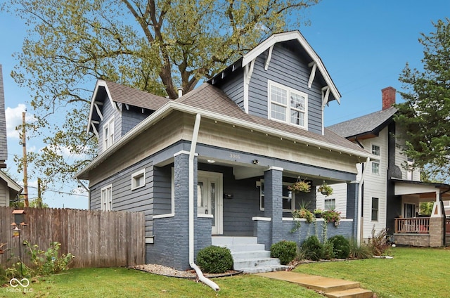 3005 Broadway St, Indianapolis, IN 46205 - view of front facade featuring a shingled roof, a front yard, covered porch, and fence