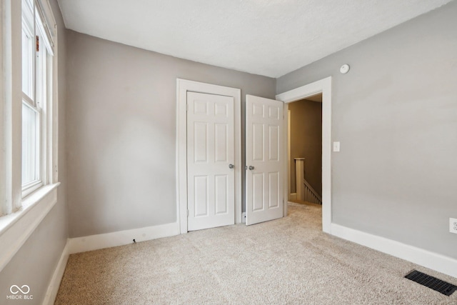 3005 Broadway St, Indianapolis, IN 46205 - unfurnished bedroom with baseboards, carpet floors, visible vents, and a closet