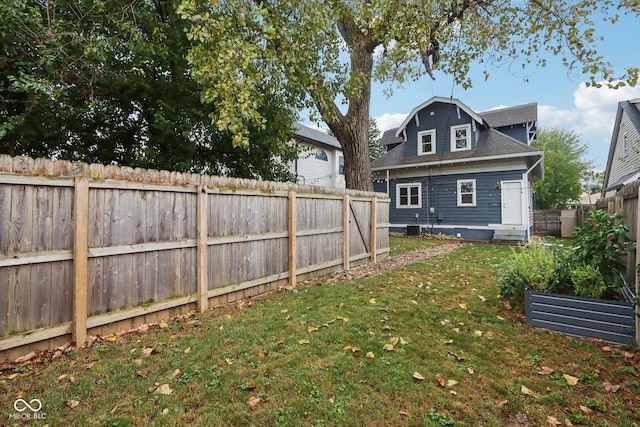 3005 Broadway St, Indianapolis, IN 46205 - rear view of property featuring a lawn, central AC, a fenced backyard, and roof with shingles