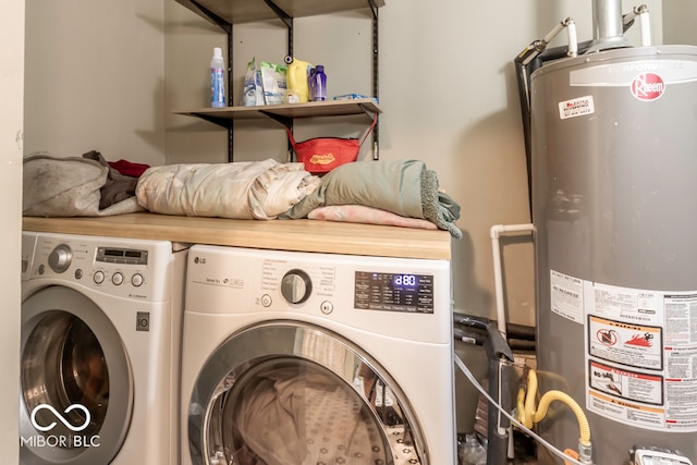 laundry area featuring water heater and washing machine and dryer