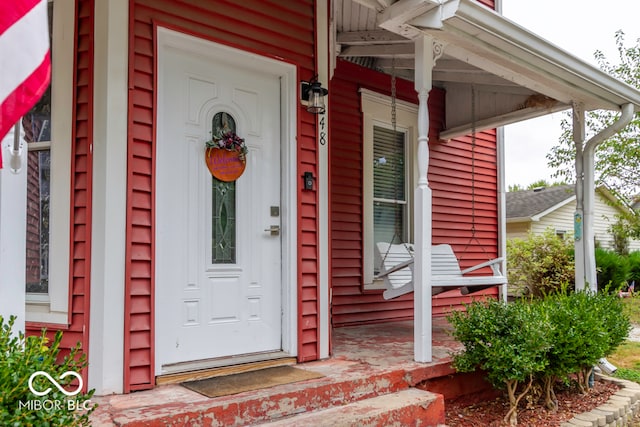 view of exterior entry featuring a porch