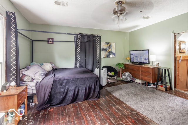 bedroom featuring wood-type flooring, ceiling fan, and a textured ceiling