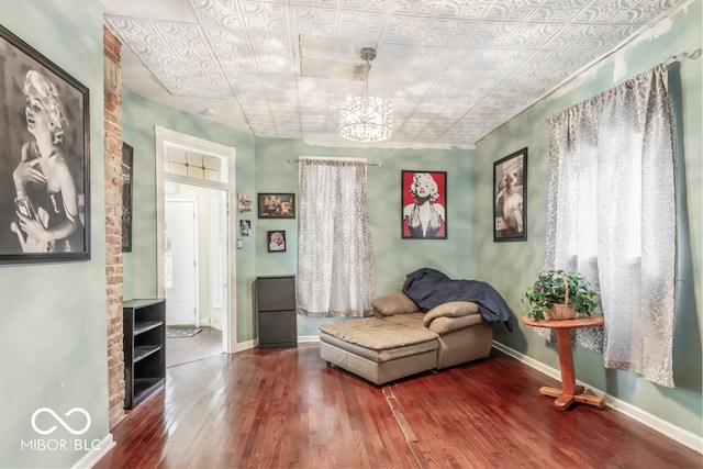 living area featuring a notable chandelier and hardwood / wood-style floors