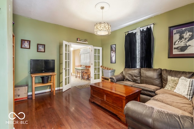 living room with french doors and dark wood-type flooring