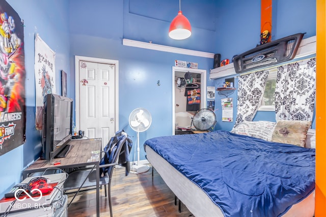 bedroom with wood-type flooring and a closet