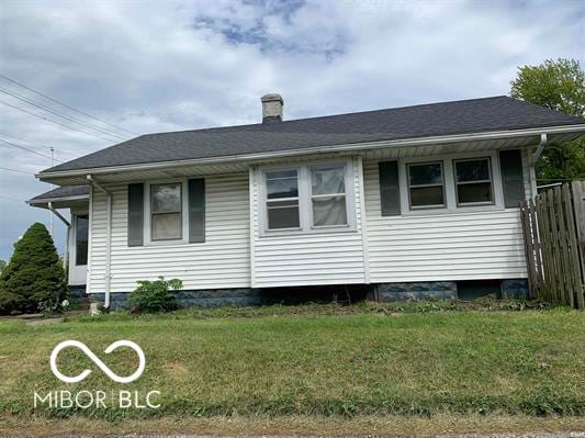 view of side of home with a lawn