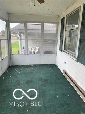 unfurnished sunroom with ceiling fan, wood ceiling, and baseboard heating