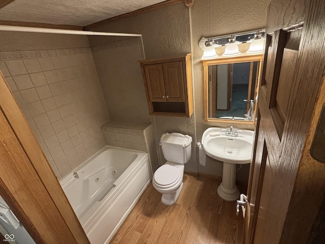 8855 N Waverly Park Rd, Martinsville, IN 46151 - bathroom with wood finished floors, a textured ceiling, a textured wall, toilet, and a combined bath / shower with jetted tub