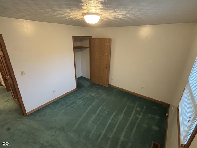 8855 N Waverly Park Rd, Martinsville, IN 46151 - unfurnished bedroom featuring visible vents, dark colored carpet, baseboards, and a textured ceiling