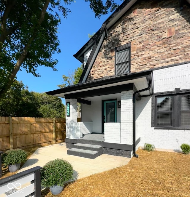 rear view of house featuring a porch