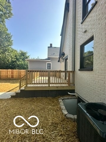 view of yard with central AC unit and a deck