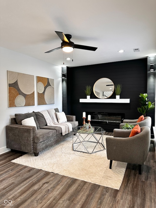 living room with ceiling fan and wood-type flooring