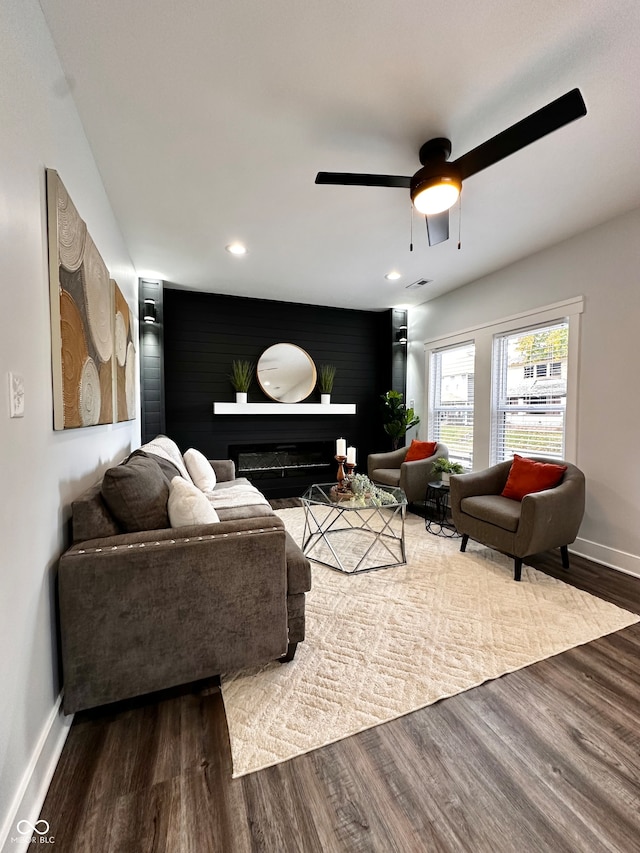 living room featuring wood-type flooring and ceiling fan