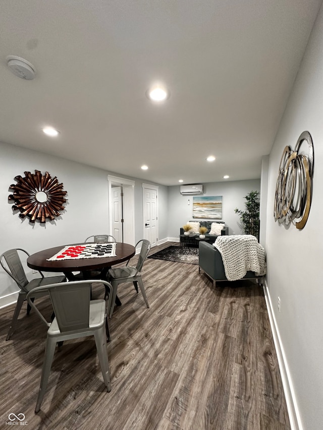 dining space with a wall mounted AC and wood-type flooring