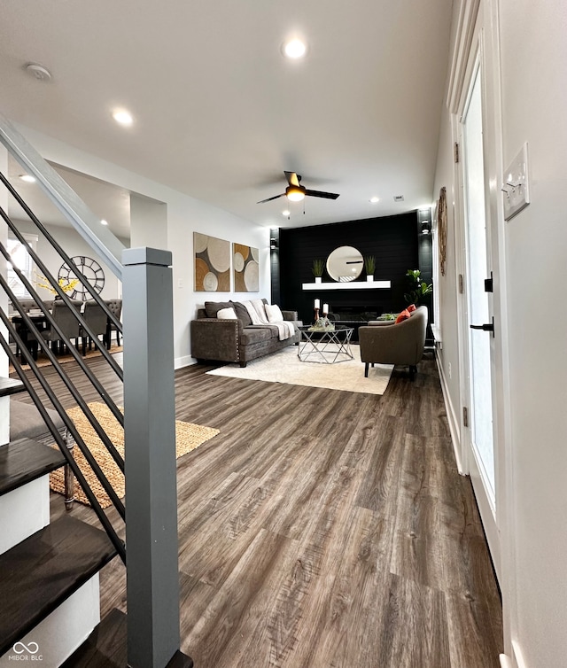 living room featuring hardwood / wood-style floors and ceiling fan