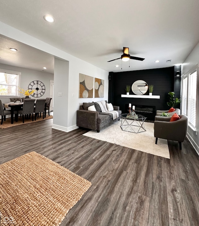 living room with dark hardwood / wood-style floors and ceiling fan