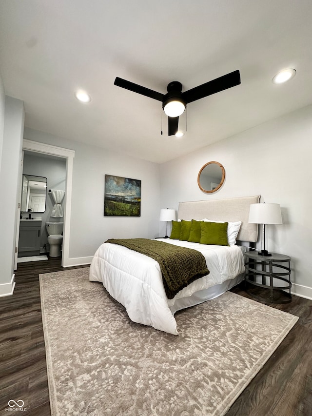 bedroom featuring ensuite bathroom, dark hardwood / wood-style flooring, and ceiling fan