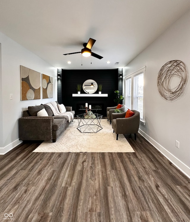 living room with hardwood / wood-style floors and ceiling fan