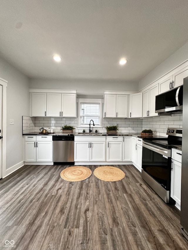 kitchen with white cabinets, sink, dark hardwood / wood-style floors, and stainless steel appliances