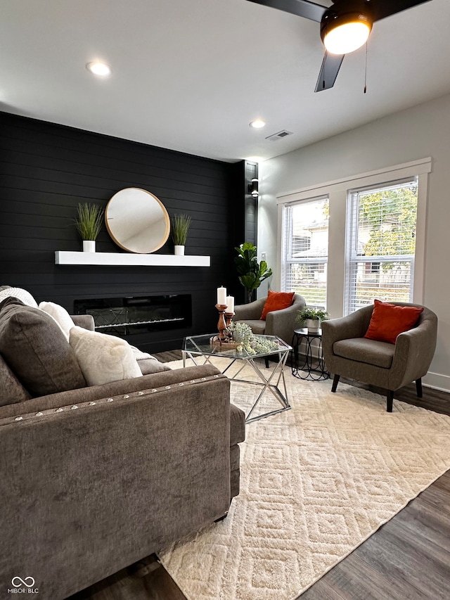 living room with hardwood / wood-style floors and ceiling fan