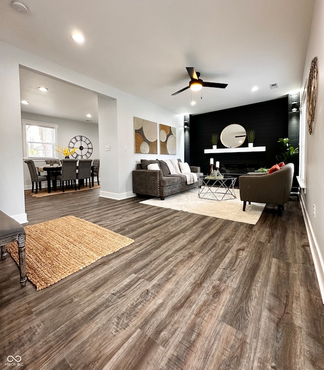 living room featuring hardwood / wood-style flooring and ceiling fan