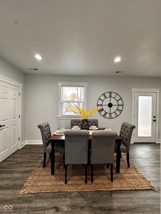 dining space with dark hardwood / wood-style flooring