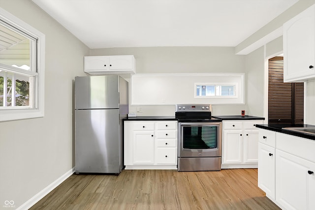 kitchen featuring appliances with stainless steel finishes, light wood-type flooring, and white cabinets