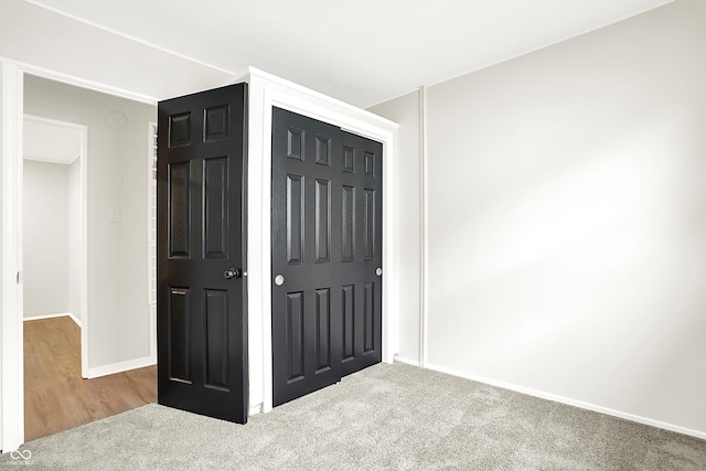 unfurnished bedroom featuring a closet and carpet