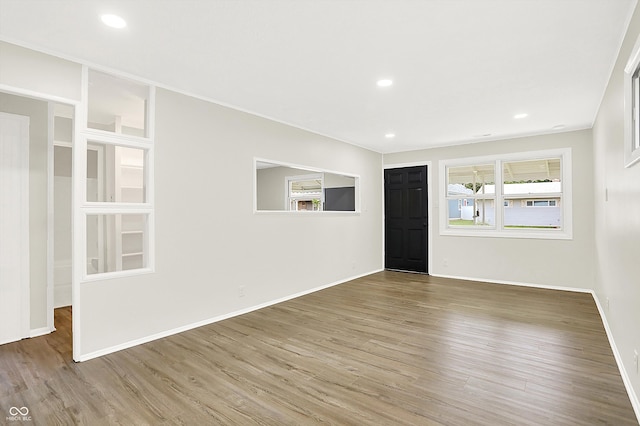 unfurnished room with hardwood / wood-style flooring