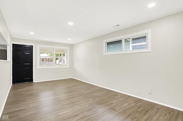 spare room featuring wood-type flooring